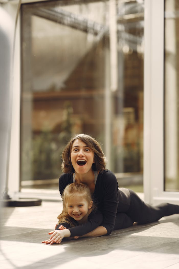 A joyful mother and daughter spend quality time together indoors, expressing happiness and love.